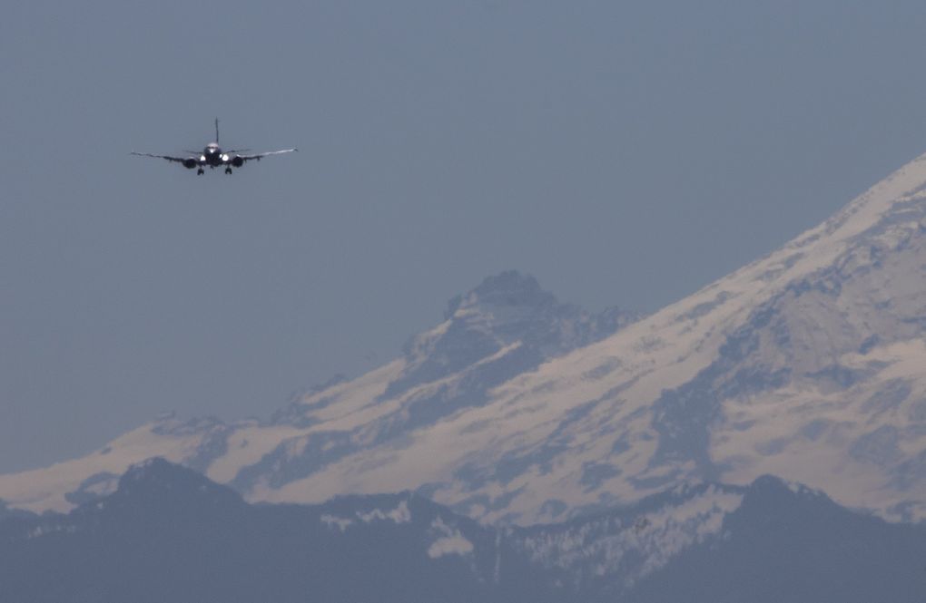 The final version of the 737 MAX, the MAX 10, flies past Mount Rainier on its way to land at Boeing Field after a trip to Eastern Washington on Friday. (Ellen M. Banner / The Seattle Times)