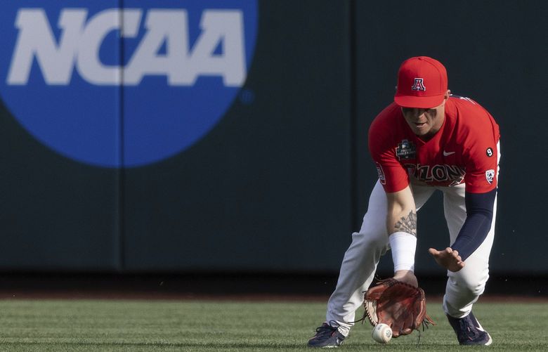 Arizona’s Ryan Holgate fields a hit by Vanderbilt’s Dominic Keegan during the first inning of a baseball game in the NCAA College World Series on Saturday, June 19, 2021, in Omaha, Neb. (AP Photo/Rebecca S. Gratz) NERG140 NERG140