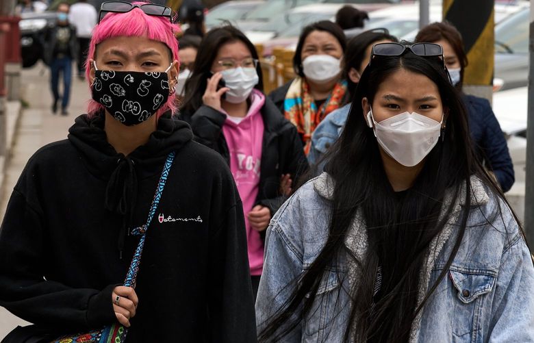 Pedestrians wear face masks in Ulaanbaatar, Mongolia, on May 12, 2021. Mongolia now ranks among the top countries that have fully vaccinated its population, inoculating about 52 percent of its people. But on Sunday, it recorded 2,400 new infections, a quadrupling from a month before. (Khasar Sandag/The New York Times)