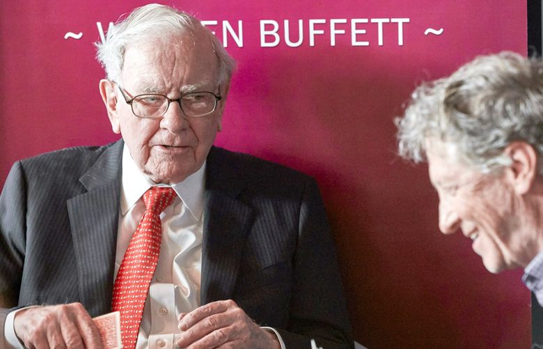 Warren Buffett, Chairman and CEO of Berkshire Hathaway, left, addresses Gill Gates, right, during a game of bridge following the annual Berkshire Hathaway shareholders meeting in Omaha, Neb., Sunday, May 5, 2019. (AP Photo/Nati Harnik) NENH106