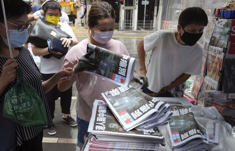 People queue up to buy last issue of Apple Daily at a newspaper booth at a downtown street in Hong Kong, Thursday, June 24, 2021. Hong Kong’s sole remaining pro-democracy newspaper has published its last edition. Apple Daily was forced to shut down Thursday after five editors and executives were arrested and millions of dollars in its assets were frozen as part of China’s increasing crackdown on dissent in the semi-autonomous city. ( AP Photo/Vincent Yu) HK106 HK106