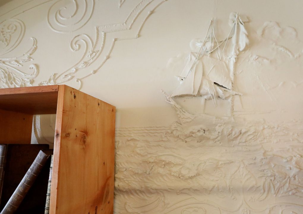A sailing ship is seen in the historical molding at Arundel Books in Pioneer Square. A series of friezes lining the vaulted ceilings of the building that now houses the bookshop depict the immigration story of the Schmidt family, creators of Olympia Brewing Company — the space’s first tenants. (Ken Lambert / The Seattle Times)