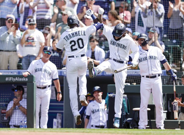 Seattle Mariners' Mitch Haniger, right, is greeted by Ty France