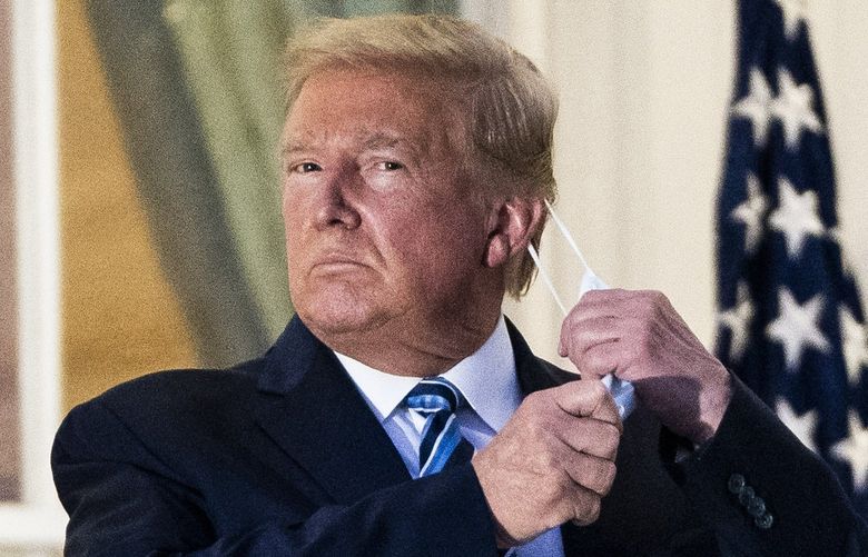 Returning to the White House after his treatment for covid-19, President Donald Trump climbed the steps to the Truman Balcony, removed his mask and saluted Marine One. MUST CREDIT: Washington Post photo by Jabin Botsford