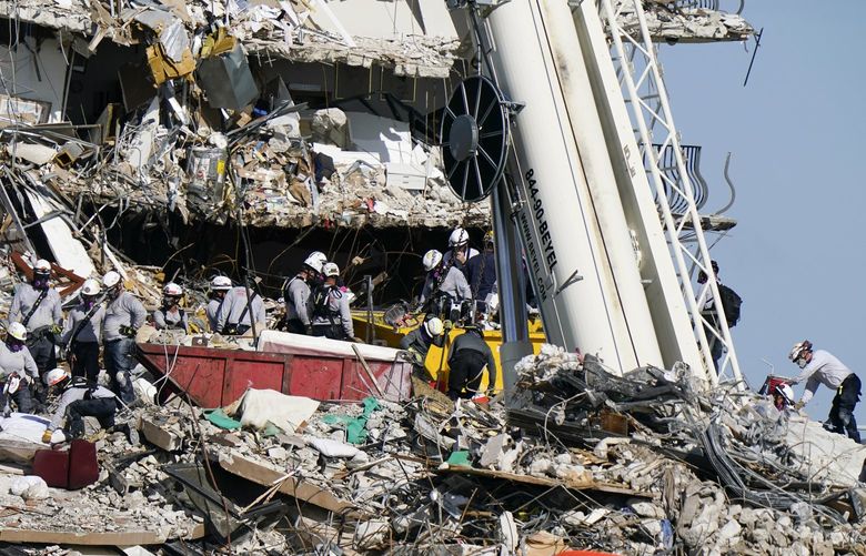 Workers search the rubble at the Champlain Towers South Condo, Monday, June 28, 2021, in Surfside, Fla. Many people were still unaccounted for after Thursday’s fatal collapse. (AP Photo/Lynne Sladky) FLLS114 FLLS114