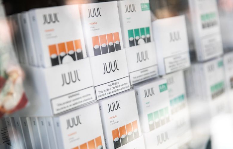 FILE — A Juul display at a store in Manhattan, Dec. 18, 2018. Three school districts on Oct. 7, 2019, filed suit against Juul, the e-cigarette manufacturer, accusing it of endangering students and forcing educators to divert time and money to fight an epidemic of nicotine addiction. (Jeenah Moon/The New York Times) XNYT235