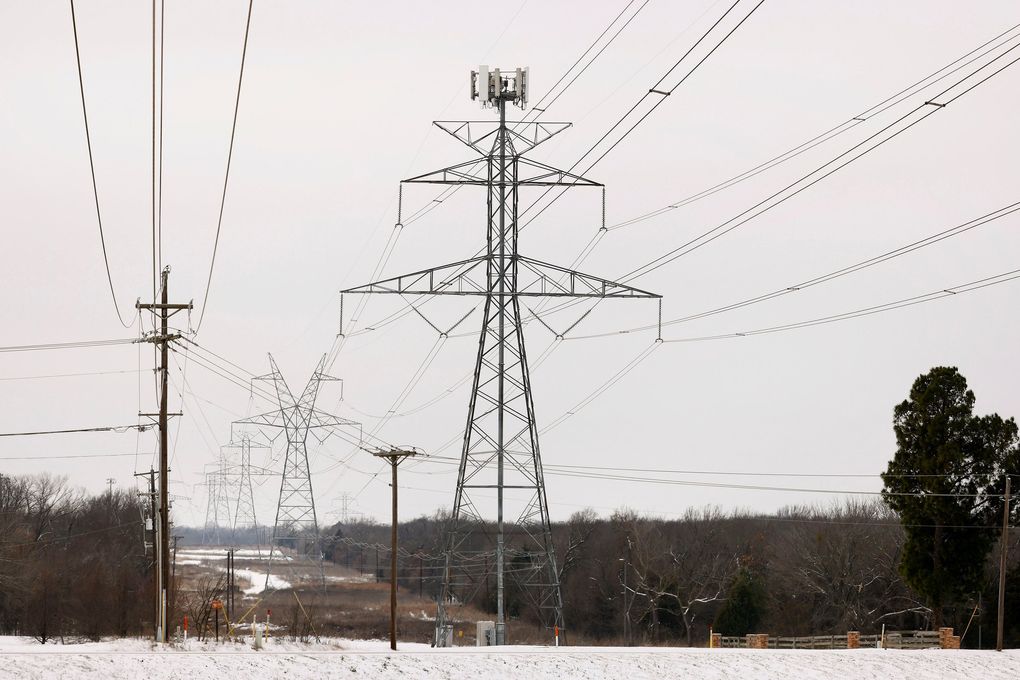 Large electrical transmission lines cross through South Arlington, Texas, on Feb. 17, 2021. Rolling power outages disrupted service to customers following snowstorms. (Tom Fox / TNS)