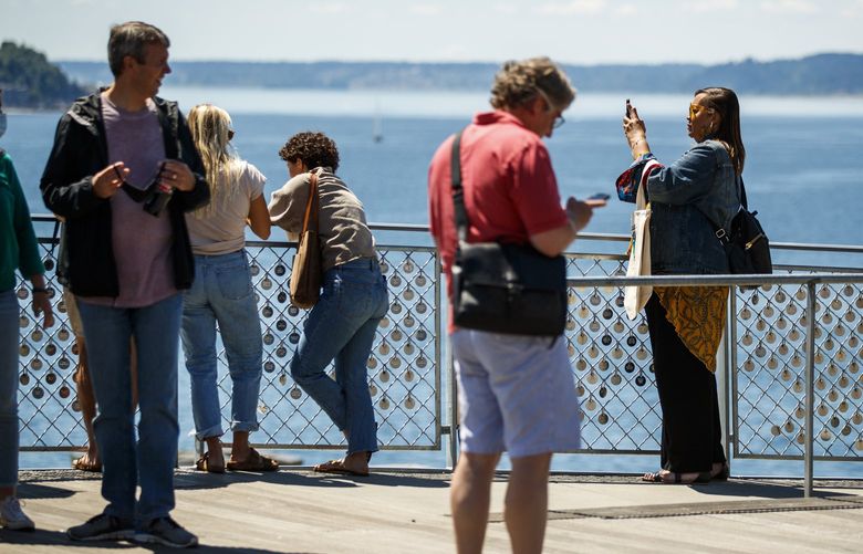 Locals and tourists take pictures of the waterfront and enjoy the view on Thursday, June 17, 2021 at Pike Place Market.

Washington state nears 70% vaccination threshold. The state will drop almost all coronavirus restrictions when we hit the 70% number or at the end of June, whichever comes sooner. Inslee’s office says we are unlikely to hit it this week.