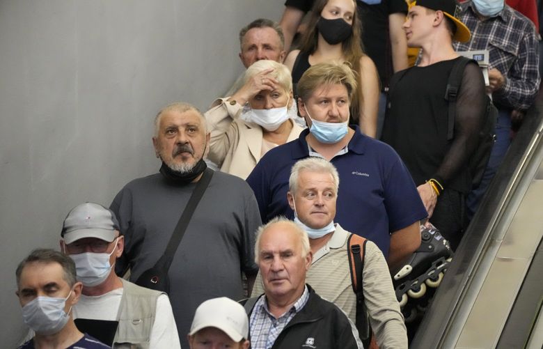 People, some of them without face masks to protect against coronavirus, ride the escalator in the subway amid the ongoing COVID-19 pandemic in St. Petersburg, Russia, Tuesday, June 29, 2021. Russia’s state coronavirus task force have registered over 20,000 new coronavirus cases and around 600 deaths every day since last Thursday.  (AP Photo/Dmitri Lovetsky) XDL103 XDL103