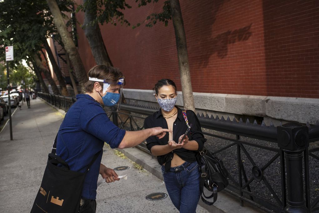 A woman shows proof of vaccination on her phone before a performance at the Park Avenue Armory in Brooklyn, N.Y. New Yorkers can download the Excelsior Pass, the nation’s first and only government-issued vaccine passport. (Victor J. Blue / The New York Times)