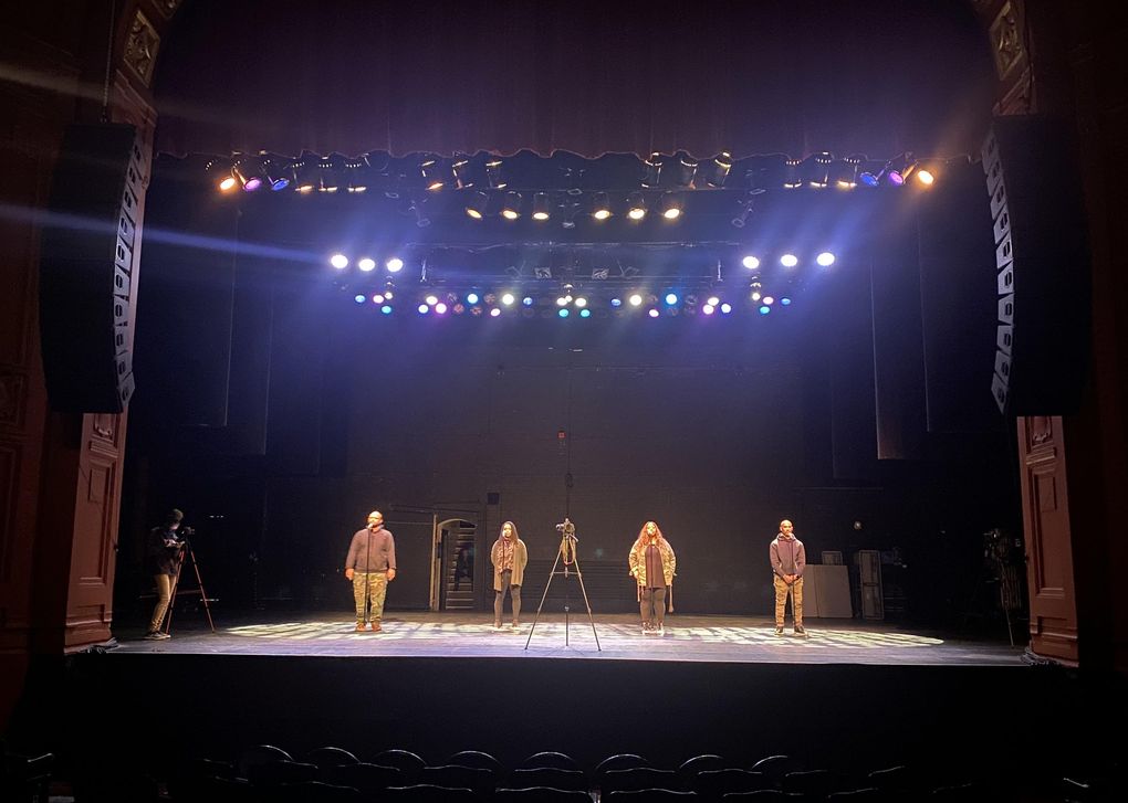 At the Moore Theatre, ELEVATE mentors — from left, Kyle Danielson, Nakeya Isabell, Tia-Nache Yarbrough and Aaron Reader — rehearse their spoken-word piece about the Moore’s history of segregation. (Courtesy of Seattle Theatre Group)