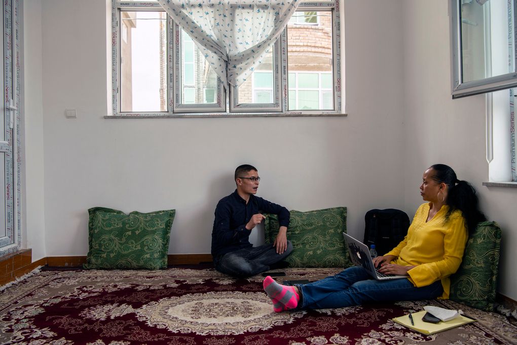 Afghan Air Force Maj. Naiem Asadi goes over some immigration paperwork with Kimberley Motley, an American human rights attorney who is helping the family emigrate, at his home in Kabul on May 29, 2021. (Kiana Hayeri / The New York Times)