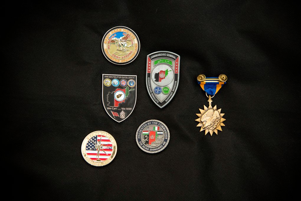 Some of the medals awarded to Afghan Air Force Maj. Naiem Asadi, shown at his home in Kabul on May 31, 2021. (Kiana Hayeri / The New York Times)