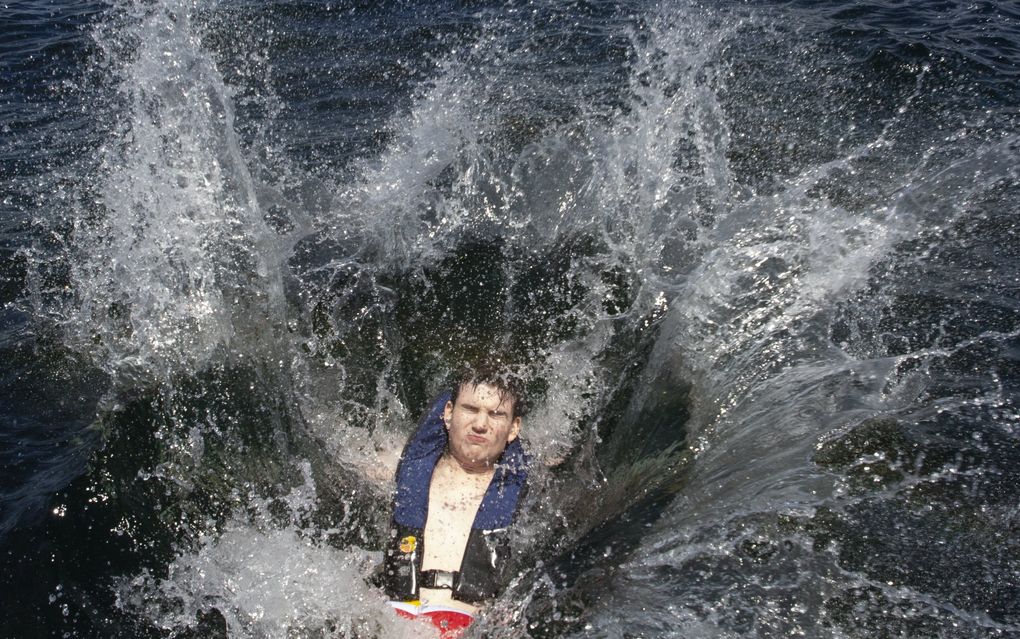 During a training drill with the King County Sheriff’s Office earlier this month, Nathan Loutsis, an explorer for the King County Sheriff’s Office falls into the water, wearing a self-acting inflatable personal flotation device off of Carillon Point in Kirkland. (Ellen M. Banner / The Seattle Times)