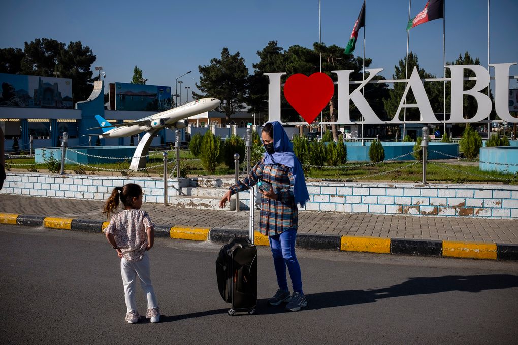 Rahima Asadi, the wife of Afghan Air Force Maj. Naiem Asadi, and their daughter, Zainab, outside the airport in Kabul on June 1, 2021. (Kiana Hayeri / The New York Times)