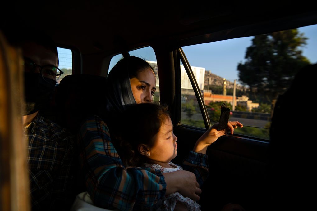 Afghan Air Force Maj. Naiem Asadi, his wife, Rahima, and their daughter, Zainab, on their way to the airport in Kabul on June 1, 2021. (Kiana Hayeri / The New York Times)