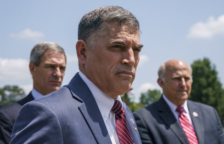 Rep. Andrew Clyde, R-Ga., center, flanked by lawyer Ken Cuccinelli, left, and Rep. Louie Gohmert, R-Texas, right, speaks at news conference about their lawsuit after they were fined for avoiding metal detectors at the House floor, at the Capitol in Washington, Monday, June 14, 2021. (AP Photo/J. Scott Applewhite)