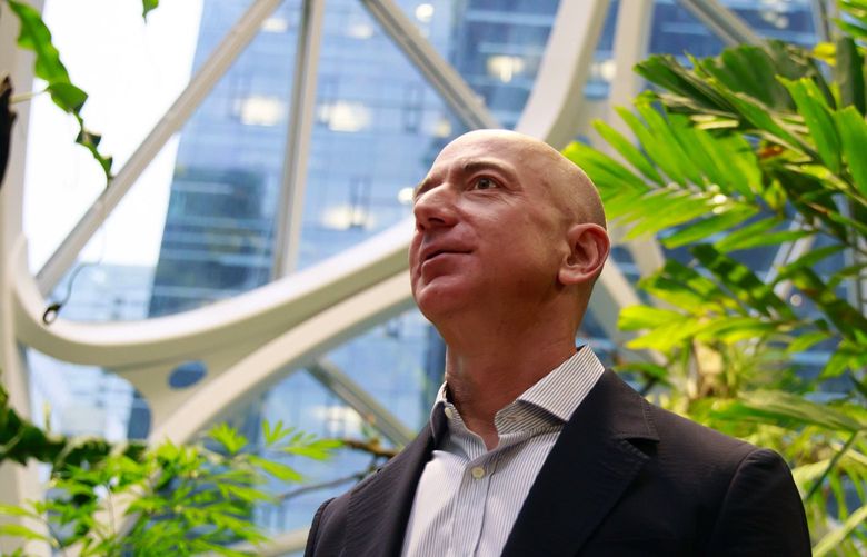 Jeff Bezos, center, tours The Spheres at Amazon’s campus in downtown Seattle Monday, Jan. 29, 2018. 
