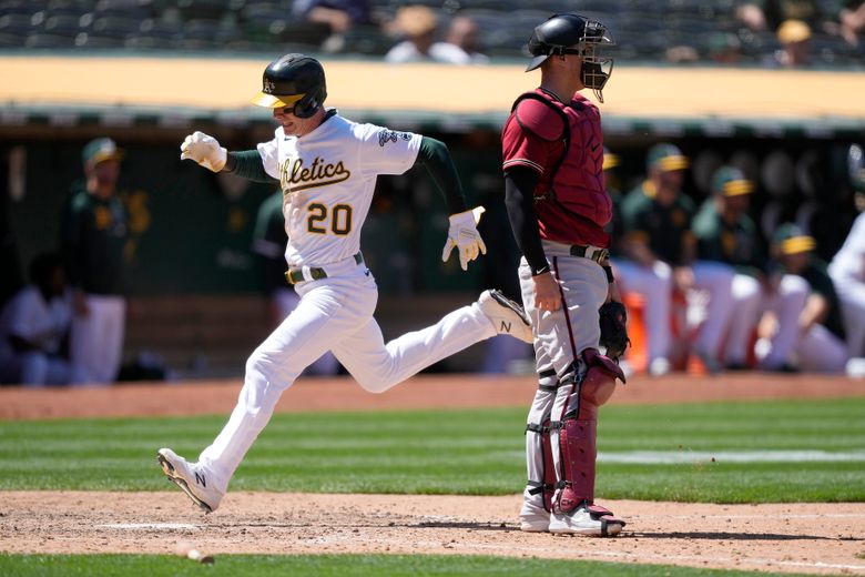 Oakland Athletics pitcher Frankie Montas, center, hands the ball