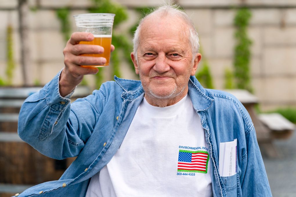 In this May 6, 2021 photo, George Ripley, 72, of Washington, holds up his free beer after receiving the J & J COVID-19 vaccine shot, at The REACH at the Kennedy Center in Washington D.C. Free beer is the latest White House-backed incentive for Americans to get vaccinated for COVID-19. President Joe Biden is expected to announce a “month of action” on Wednesday to get more shots into arms before the July 4 holiday. (AP Photo/Jacquelyn Martin)