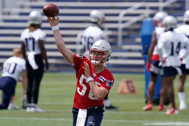 New England Patriots quarterback Mac Jones (10) hands off the ball