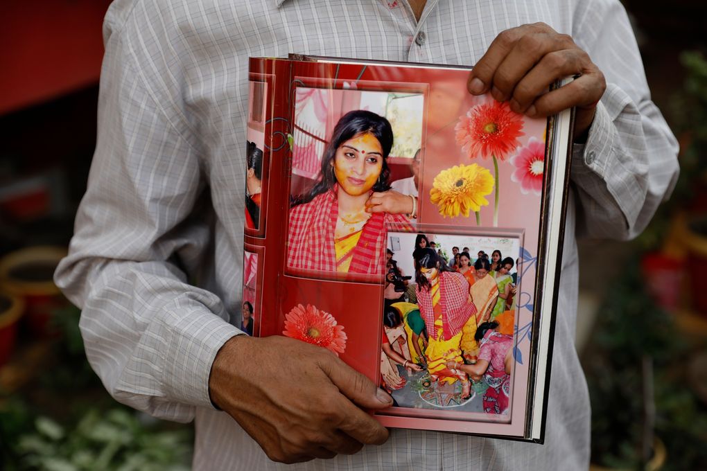 Radha Gobindo Pramanik holds photographs of his daughter who died of COVID-19 in Lucknow, India, Thursday, June 3, 2021. Two months ago Pramanik and his wife threw a party to celebrate their daughter’s pregnancy and the upcoming birth of their long-awaited grandchild. Within days, his wife, his daughter and his unborn grandchild were all dead, among the tens of thousands killed as the coronavirus ravaged India in April and May. (AP Photo/Rajesh Kumar Singh)