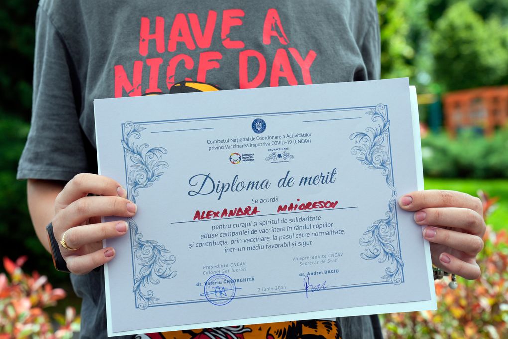 Alexandra Maiorescu holds a diploma received after she got a Pfizer BioNTech COVID-19 vaccine in Bucharest, Romania, Wednesday, June 2, 2021. Romania has started the vaccination campaign for children between the ages of 12 and 15. (AP Photo/Vadim Ghirda)