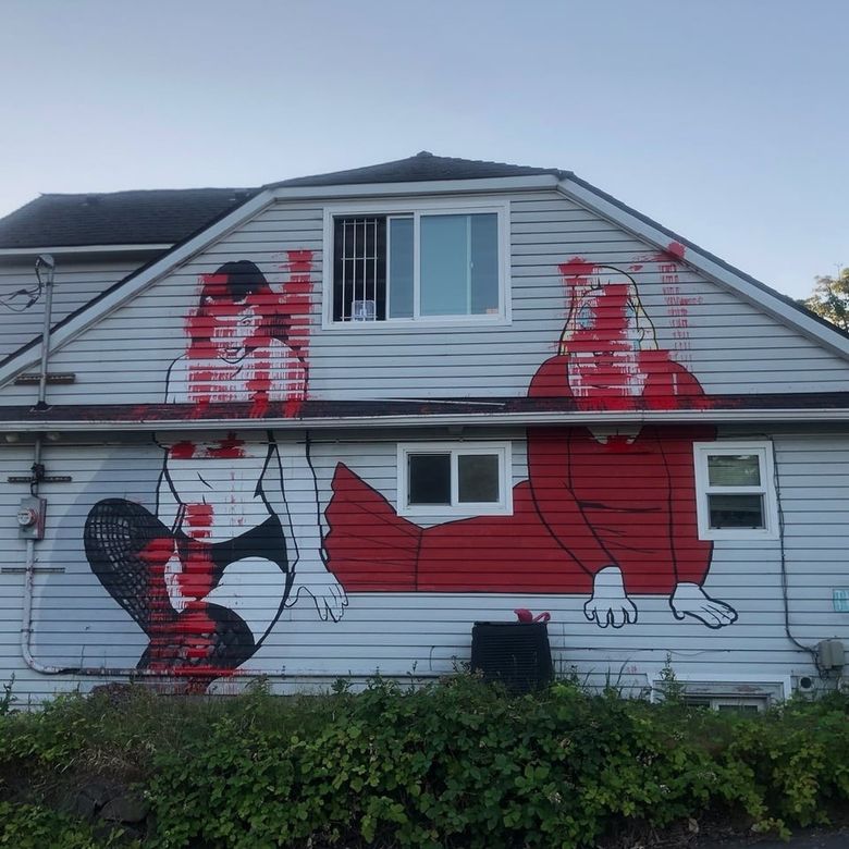 Seattle's iconic Bettie Page mural, visible from I-5, defaced with