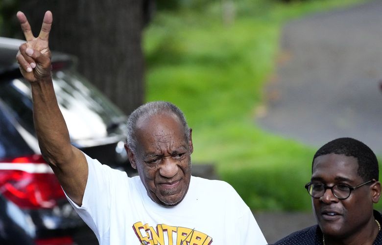 Comedian Bill Cosby, center, and spokesperson Andrew Wyatt, right, approach members of the media gathered outside Cosby’s home in Elkins Park, Pa., Wednesday, June 30, 2021, after Pennsylvania’s highest court overturned his sex assault conviction. (AP Photo/Matt Slocum) PNA708 PNA708