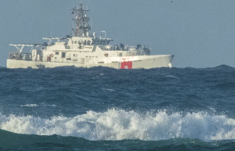 A U.S. Coast Guard cutter patrols the area of debris from a 737 cargo plane that crashed off Oahu, Friday, July 2, 2021, near Honolulu. The plane made an emergency landing in the Pacific Ocean off the coast of Hawaii early Friday and both people on board were rescued. The pilots of the Transair Flight 810 reported engine trouble and were attempting to return to Honolulu when they were forced to land the Boeing 737 in the water, the Federal Aviation Administration said in a statement. (Craig T. Kojima/Honolulu Star-Advertiser via AP) HIHON501 HIHON501