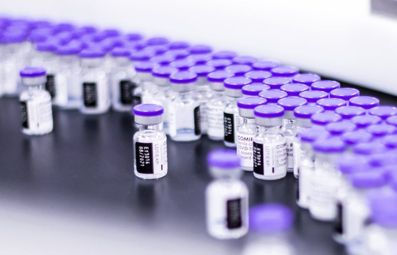 In this March 2021 photo provided by Pfizer, vials of the Pfizer-BioNTech COVID-19 vaccine are prepared for packaging at the companyâ€™s facility in Puurs, Belgium. Pfizer is about to seek U.S. authorization for a third dose of its COVID-19 vaccine, saying Thursday, July 8, 2021, that another shot within 12 months could dramatically boost immunity and maybe help ward off the latest worrisome coronavirus mutant. (Pfizer via AP) HOPF104 HOPF104