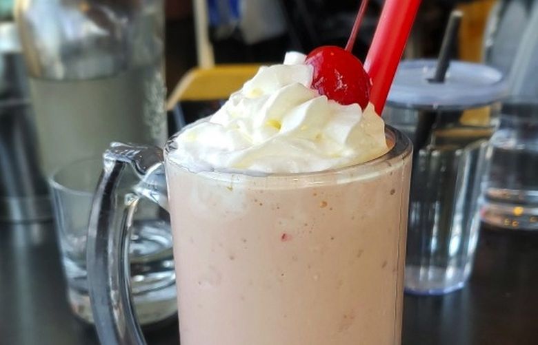 The adult milkshakes get shots of booze, fluffy hats of aerosol whipped cream and large-gauge straws to help accelerate them milkshake into their adult at Stack 571. Courtesy of Stack 571 Burger & Whiskey Bar