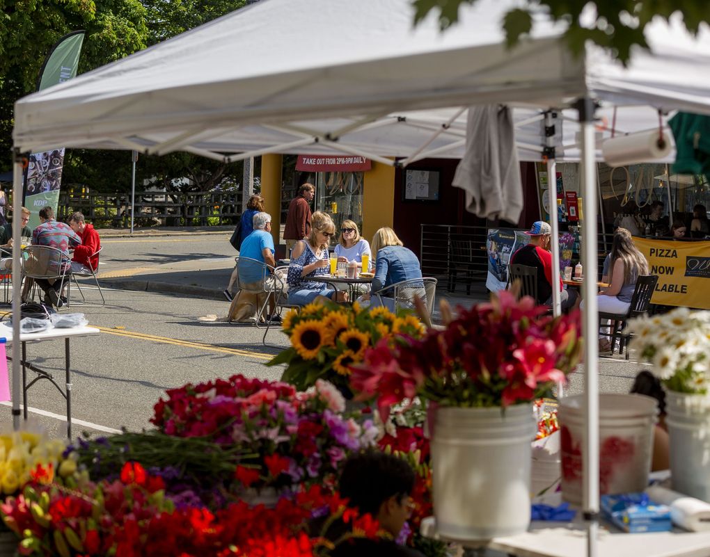 People dine outdoors at Inside OUT Open Air Dining & Marketplace on July 10 in Kent. (Sylvia Jarrus / The Seattle Times)