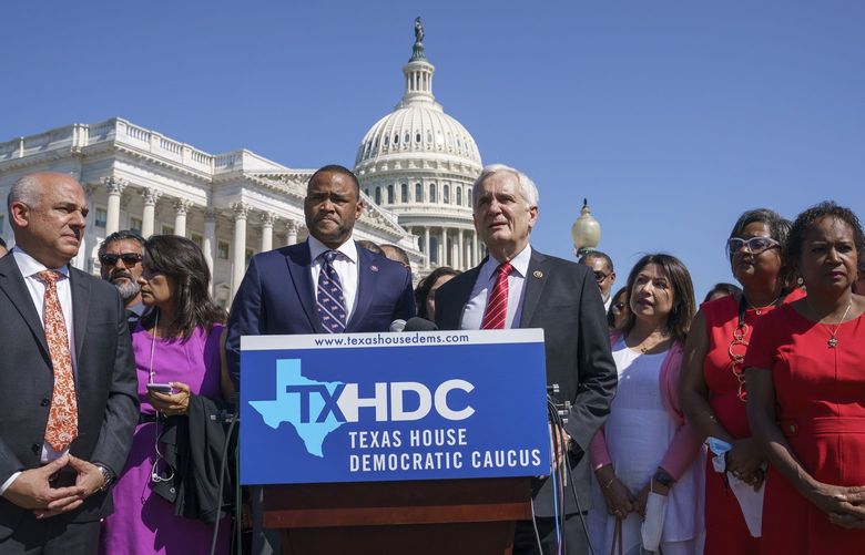 Rep. Marc Veasey, D-Texas, center left, and Rep. Lloyd Doggett, D-Texas, joined at left by Rep. Chris Turner, chairman of the Texas House Democratic Caucus, welcome Democratic members of the Texas legislature at a news conference at the Capitol in Washington, Tuesday, July 13, 2021. The lawmakers left Austin hoping to deprive the Texas Legislature of a quorum â€” the minimum number of representatives who have to be present for the body to operate, as they try to kill a Republican bill making it harder to vote in the Lone Star State. (AP Photo/J. Scott Applewhite) DCSA102 DCSA102