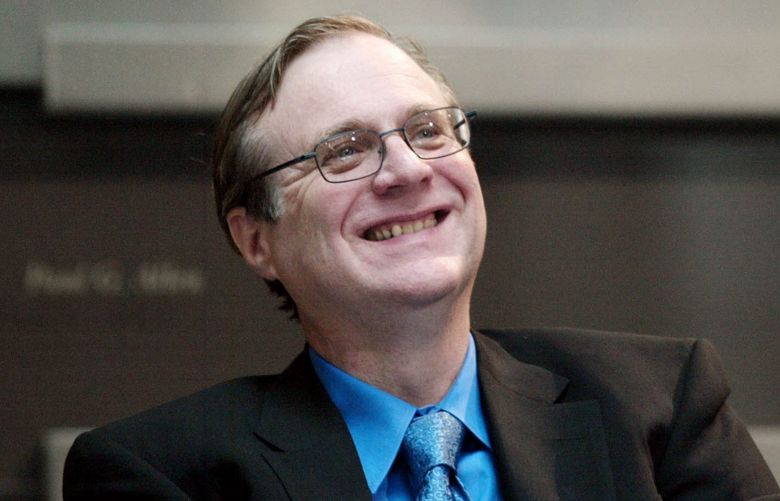 Paul Allen, Microsoft co-founder, smiles as he listens to other speakers during the dedication of the Paul G. Allen Center for Computer Science & Engineering at the University of Washington in Seattle on Thursday, Oct. 9, 2003. (AP Photo/John Froschauer)