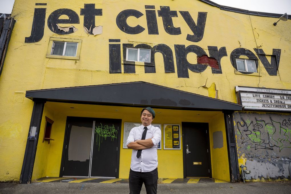 Michael Yichao, 33, stands in front of Jet City Improv on July 16 in the University District, where he used to work and put on shows. Yichao is a queer Asian American actor and writer in Seattle. His focus is on improv and comedy acting and he says he has turned down roles in the past because they were based off of stereotypes or lacked nuance. (Sylvia Jarrus / The Seattle Times)