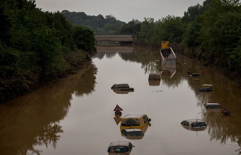 Submerged cars stranded in floodwaters along State Road 265 near Erftstadt, Germany, July 17, 2021. Floods swept Germany, fires ravaged the American West and another heat wave loomed, driving home the reality that the world’s richest nations remain unprepared for the intensifying consequences of climate change. (Gordon Welters/The New York Times)