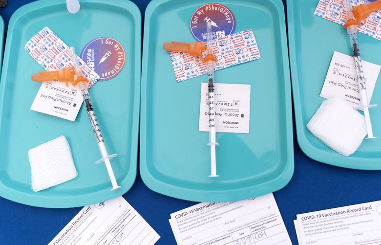 Pfizer COVID-19 vaccine doses are prepared for members of the community 12 years and up, Wednesday, May 19, 2021, at a clinic held by Community of Hope, outside the Washington School for Girls in southeast Washington. Neighborhood schools sent information about the vaccines to their students’ families to ensure access to the vaccine, that’s been recently approved for children ages 12-15. (AP Photo/Jacquelyn Martin)