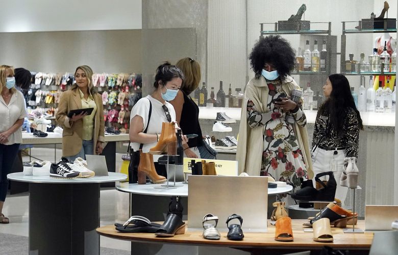 Shoppers browse a shoe department at the Nordstrom NYC Flagship store, in New York, Wednesday, July 14, 2021. .  (AP Photo/Richard Drew) 