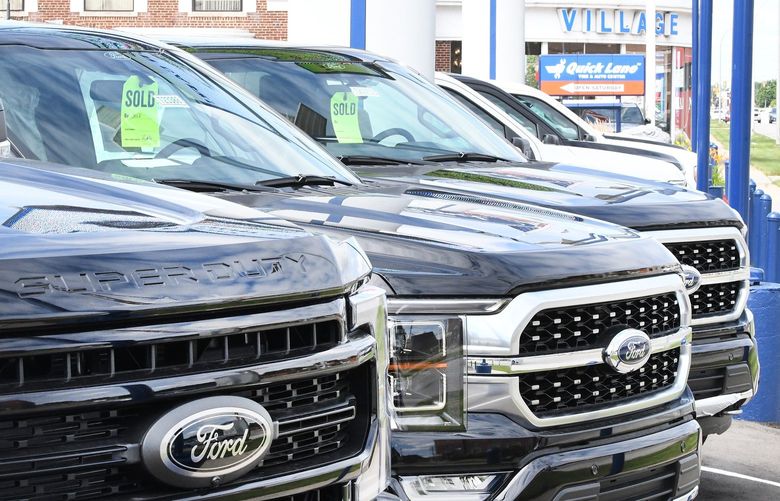 New Ford trucks, many with ‘sold’ stickers already attached, sit in the lot at Village Ford in Dearborn, July 9, 2021. (Daniel Mears/ The Detroit News/TNS) 21798389W 21798389W