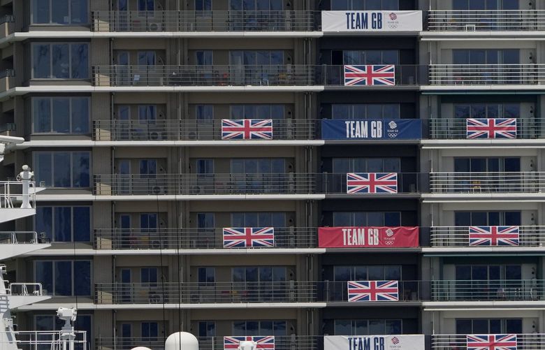 Flags and banners hang from Great Britain team apartments in the Olympic athletes’ village ahead of the 2020 Summer Olympics, Monday, July 19, 2021, in Tokyo. (AP Photo/Charlie Riedel) OLYCR130 OLYCR130