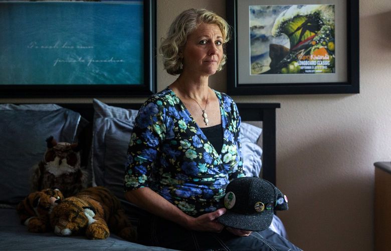 Jerri Clark sits in Calvin’s childhood room holding his hat that he wore often while homeless, in Vancouver, Wash. Calvin loved to surf, which was reflected in his room decor, and won awards in speech and debate. 

His mother Jerri struggled to navigate Washington’s overtaxed and complicated mental health system as her son spiraled into homelessness and his condition became worse. Calvin was finally able to find supportive and permanent housing in Seattle, but after about six months in permanent housing, he died by suicide.

June 10, 2021.