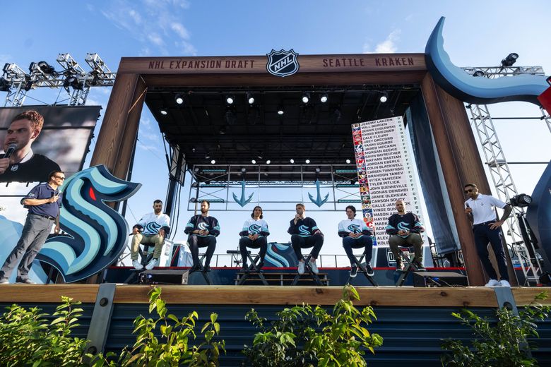The Kraken’s first franchise players are introduced as a group Wednesday at the NHL expansion draft at Gas Works Park. From left: right wing Jordan Eberle; goalie Chris Driedger; left wing Brandon Tanev; and defensemen Jamie Oleksiak, Haydn Fleury and Mark Giordano. (Dean Rutz / The Seattle Times)