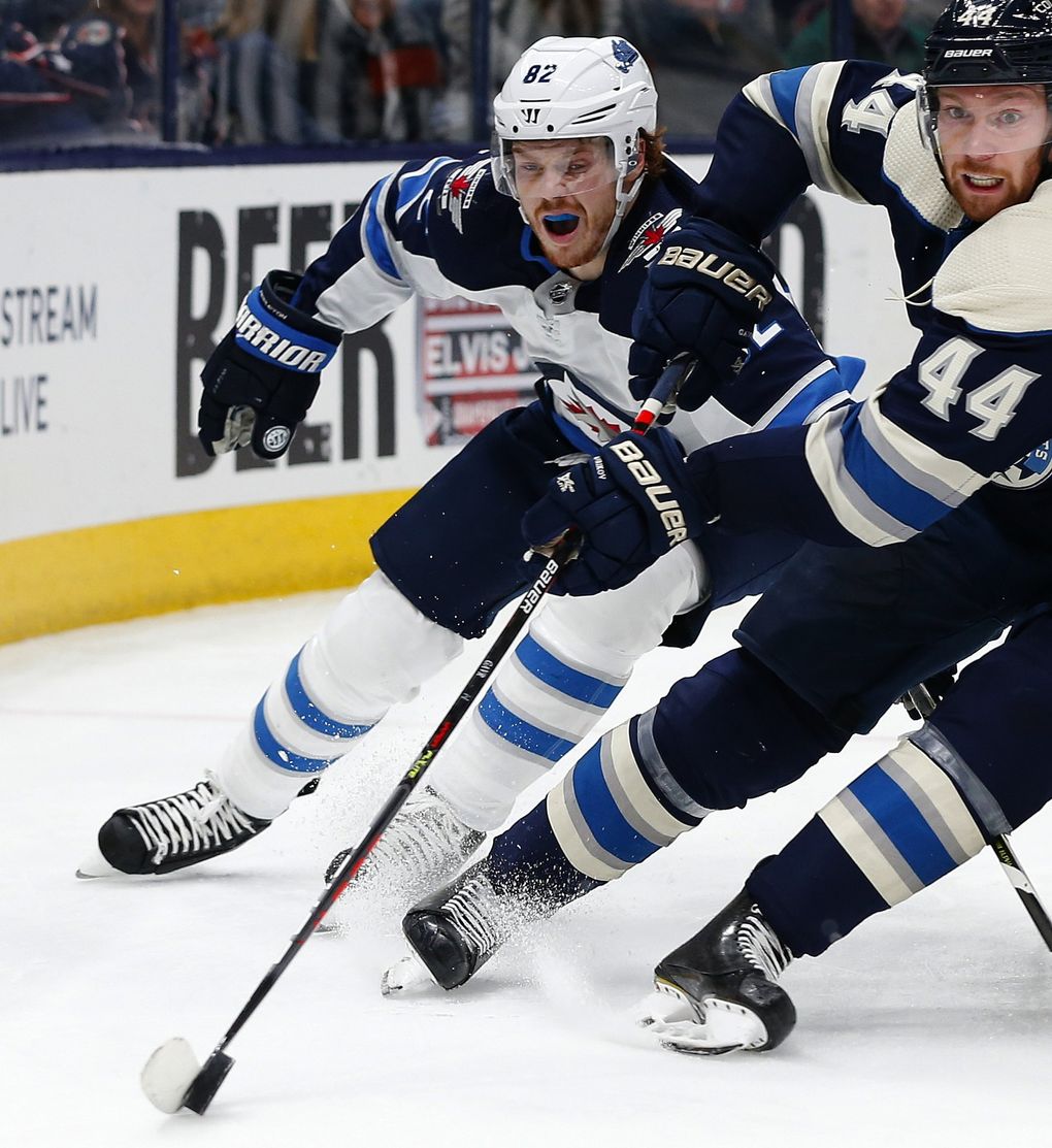 Columbus Blue Jackets’ Vladislav Gavrikov, right, of Russia, tries to clear the puck as Winnipeg Jets’ Mason Appleton defends during the third period of an NHL hockey game Wednesday, Jan. 22, 2020, in Columbus, Ohio. The Blue Jackets defeated the Jets 4-3. (Jay LaPrete / AP)