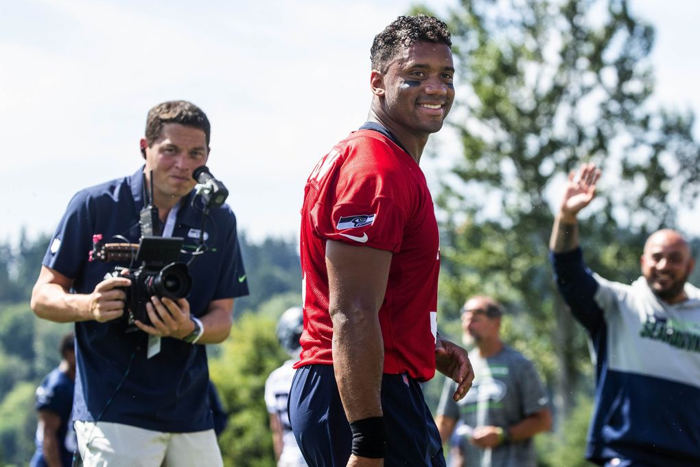 Russell Wilson smiles as cries of “Daddy” come from his children (Dean Rutz / The Seattle Times)