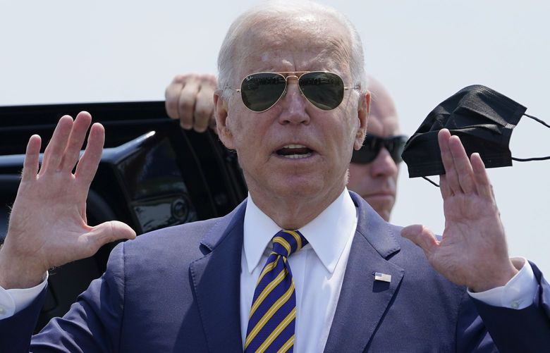President Joe Biden holds a mask as he responds to a question as he arrives at Lehigh Valley International Airport in Allentown, Pa., Wednesday, July 28, 2021. Biden is in the area to visit the Lehigh Valley operations facility for Mack Trucks and advocate for government investments and clean energy as ways to strengthen U.S. manufacturing. (AP Photo/Susan Walsh) PASW101 PASW101