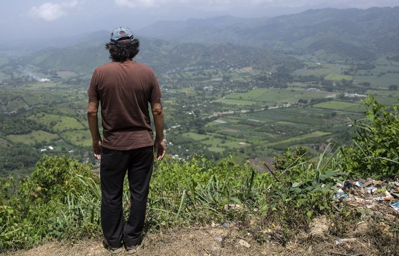 Friar Leopoldo Serrano surveys the landscape where he built a rehab center for drug addicts, in Mission San Francisco de Asis, Honduras, Tuesday, July 15, 2021.  As Serrano stood on the lookout over the valley, he said, â€œHalf of all the land and businesses you see from here belong to drug traffickers.” (AP Photo/Rodrigo Abd) XABD523 XABD523