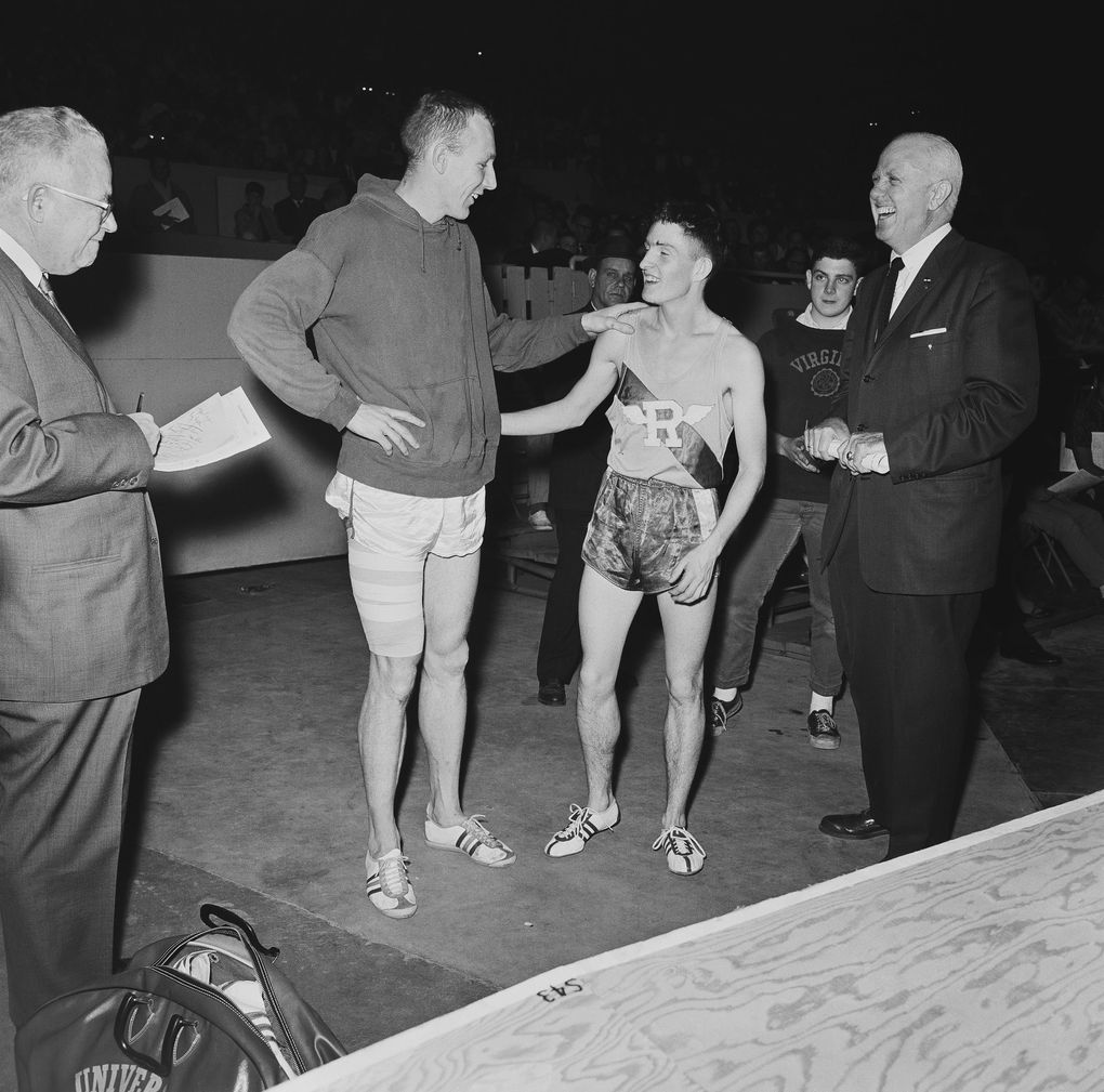 Phil Shinnick of Washington, left, his leg taped, congratulates Spokane’s Gerry Lindgren on winning the two-mile event in the San Francisco Holiday Invitational track meet on Dec. 28, 1963. Shinnick won the broad jump with a leap of 25-feet 6½ inches. Lindgren, of Rogers High School, carded 9 minutes flat for the two-mile. (Robert W. Klein / AP)