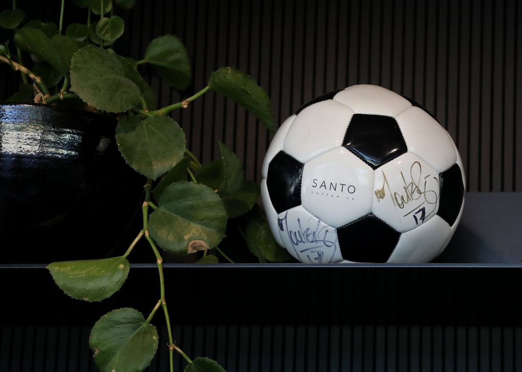 There are no photographs of Fredy Montero in his Santo Coffee shop in Ravenna, but there is this signed soccer ball. He’s a co-owner of Santo Coffee Company. (Alan Berner / The Seattle Times)