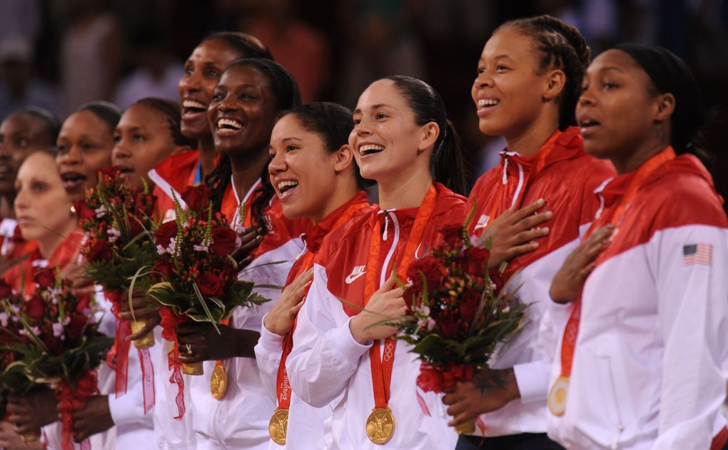 Members of the USA gold medal winning women’s basketball team sing the Star Spangled Banner during the medal ceremonies after they routed Russia for the title. (ROD MAR / The Seattle Times)